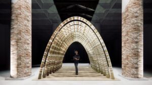 Arched woven installation inside the brick-columned Corderie interior